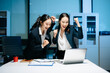 © Nuttapong punna - Two businesswomen celebrating success after achieving goals at office desk. Teamwork, motivation, leadership, startup growth and modern corporate workplace.