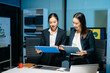 © Nuttapong punna - Two professional businesswomen analyzing reports and planning strategy at office desk. Teamwork, collaboration, management, consulting and modern corporate workplace.