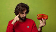 © kues1 - young adult bearded man with a red pepper