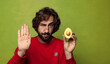 © kues1 - young adult bearded man with an avocado