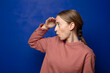© kues1 - blonde woman looking bewildered and astonished, with hand over forehead looking far away, watching or searching