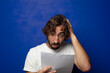© kues1 - young adult bearded man holding a sheet of paper