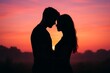 © yuvaraj - Silhouette of a couple kissing at sunset on the beach