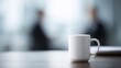 © Firadoaw - Professional workplace atmosphere with coffee mug in sharp focus, coworkers blurred, calm and modern setting