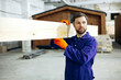 © Petro - Male worker with wooden bars for modular buildings