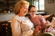 © Geber86 - Grandmother and granddaughter using smartphone at home