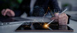 © InfiniteFlow - A business professional engages with digital financial data on a tablet while using a laptop, focusing on growth trends and analytics in a modern office environment. Scalp