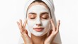 © mashimara - Young woman with white facial mask and towel on head on white background illustrating skincare, beauty routine and calm self care with clean minimal aesthetic