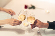 © kieferpix - Couple Romantic Wine Toast at Intimate Candle Light Dinner Table With Red Rose