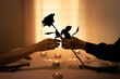 © kieferpix - Romantic Candlelight Dinner with Rose Gift, Couple Sharing Red Rose During Intimate Dinner, Valentines Day celebration