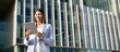 © Stock 4 You - Smiling woman in suit working using touchpad computer. Successful Latin CEO entrepreneur businesswoman in suit holding digital pc tablet outdoor at business office skyscraper. Web banner, copy space