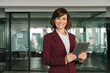 © Stock 4 You - Portrait at camera professional executive woman in suit working using computer for business bank work. Smiling mature Latin entrepreneur businesswoman CEO holding digital tablet in office. Copy space