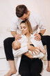 © DSMT - Intimate Family Portrait Capturing the Loving Connection Between Parents and Their Newborn Baby, Celebrating Affection, Joy, and Togetherness in a Beautiful and Serene Artistic Photograph
