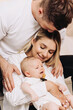 © DSMT - A Joyful Family Portrait Loving and Caring Parents Embrace Their Baby in a Heartwarming Moment that Captures the Essence of Family Love and Togetherness, Filled with Smiles and Tenderness