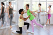 © JackF - Thin teenage boy and girl doing together arabesque position of ballet during choreography classes