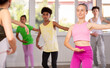 © JackF - Group of boys and girls teenage dancers performing ballet movements in dance class