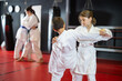 © JackF - Boy and a teenage girl work in pairs and practice karate strokes. Karate training for children of different ages