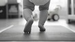 © vefimov - A baby taking first steps on a mat indoors.