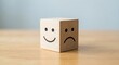 © Lianlian Liang - Wooden block cube featuring happy and sad face emotions for customer feedback and satisfaction survey concept