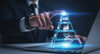 © Qutbudin - Businessman interacting with glowing hr pyramid on laptop representing human resources management and analytics