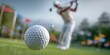 © anstam - The golf ball in sharp focus with golfer swinging on blurred green background