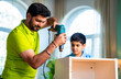 © StockImageFactory - Indian Father demonstrates furniture assembly skills to curious child at home
