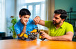© StockImageFactory - Indian father helping kid repair toy using screw driver at home