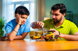 © StockImageFactory - Indian father helping kid repair toy using screw driver at home