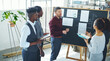 © Hinrichsen/peopleimages.com - Training, question or team in office with board, insight or advice in interior design project. Collaboration, people or architects in agency with coaching, guidance or feedback on property report.