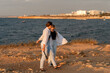 © svetograph - Couple Walking Beach Sunset Malta - Romantic walk on the beach in Malta at sunset with the couple embracing.