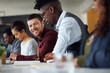 © Hinrichsen/peopleimages.com - Portrait, man and staff writing in office for training, planning and reminder notes for copywriting. Smile, person and team with notebook in meeting, coaching tips and brainstorming ideas of headline