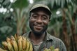 © Lubos Chlubny - African farmer smiling holding fresh ripe bananas