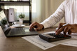 © onephoto - Accountant with US tax forms Accountant uses calculator tax papers falling review tax forms and financial documents, business accounting, tax filing preparation