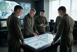 © EdienuFoto - Military officers analyzing data on interactive digital table