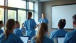 © miss irine - Medical staff attend training session in modern conference room. Professionals listen to presenter, learn new health care techniques, advance skills, discuss patient care.