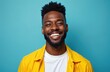 © miss irine - Smiling African American man wears a bright yellow jacket and white t-shirt. He has dark skin and hair and poses against a solid blue background with a joyful and confident expression.