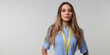 © Andrii Zastrozhnov - Confident young caucasian female with long hair standing with lanyard in blue outfit