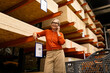 © Ivan Traimak - Smiling woman shopping for wood materials in a hardware store during daytime