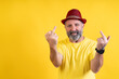 © Ceballos - Smiling man showing middle fingers expressing defiance