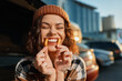 © SHOTPRIME STUDIO - Woman smile fries candid golden beanie urban joyful lifestyle playful scene at golden hour glow, authenticity and emotional storytelling capture mindful living and spontaneous grin.