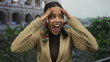 © Krakenimages.com - Woman excited with i-voted badge near roman-coliseum outdoors in italy showing joy and enthusiasm for civic participation with historic architecture in background