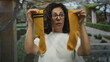 © Krakenimages.com - Middle aged hispanic woman holds mismatched socks with both hands while looking at them in park; playfulness individuality spontaneity.