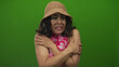 © Krakenimages.com - Middle age hispanic woman crosses arms over bare shoulders in a studio; cold discomfort vulnerability.