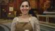 © Krakenimages.com - Woman in apron expressing emotion in a church setting, showcasing indoor lighting and architecture.