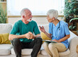 © Lumos sp - Portrait of a senior doctor or nurse caregiver talking consultation with senior man at home or nursing home