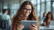 © LimeSky - Joyful girl student using a tablet in a contemporary indoor university setting