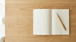 ©  Elvira Astahova - Minimalist notebook with a pen resting on wooden table