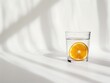 © Enes - Generative AI water glass with orange slice in sunlight