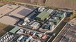 © AmazingAerialAgency - Aerial view of the National Grid Walpole Substation, a complex of green and grey structures against a backdrop of fields, Walpole, Wisbech, United Kingdom.