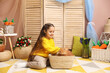 © New Africa - Little girl with cute Easter bunny in wicker basket indoors